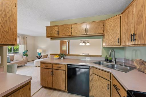 Stay connected while cooking, with views into the living room and a wide pass-through to the dining areaâplus plenty of cabinetry to keep things organized.