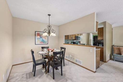 A dedicated dining area makes room for everyday meals and special occasions, with the kitchen just steps away and a wide pass-through for easy serving.