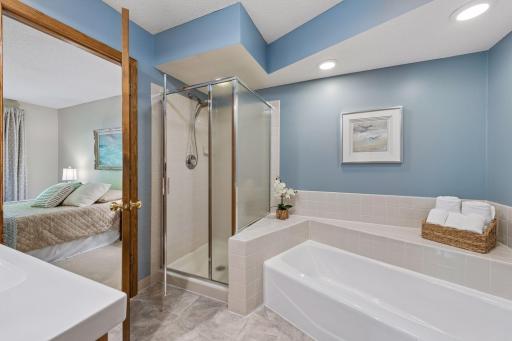 Enjoy direct access from the primary bedroom to the spacious bathroom, featuring a separate shower and a tub for unwinding at the end of the day.