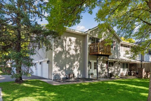 Mature trees frame this corner home, with its own private entrance and a brand-new deck aboveâa welcoming place to come home to.
