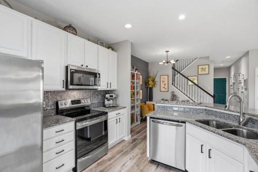 Kitchen has a continuation of the flooring plus stainless appliances.
