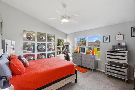 Large windows in the primary bedroom, vaulted ceiling.