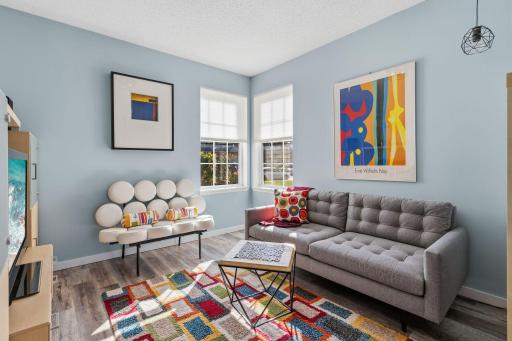 Corner windows in the den provide more natural light. Neutral basics allow you to add your own personality!