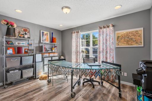 Third bedroom is currently being used as an office. Large windows allow the sun to shine in.