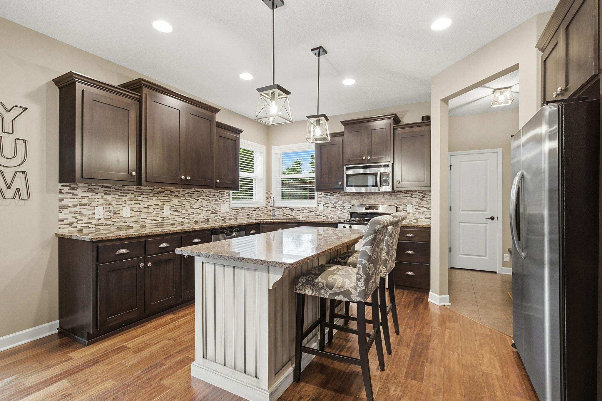 Beautifully updated kitchen featuring rich cabinetry, granite countertops, center island and good cabinet space.