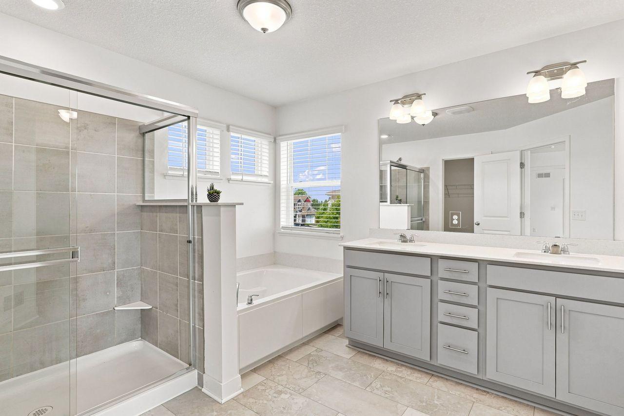 Private primary bathroom with soaking tub and walk in shower