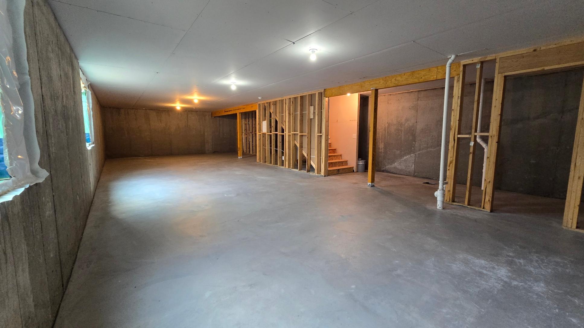 Expansive unfinished lower level ready to finish to your specifications with bathroom rough ins