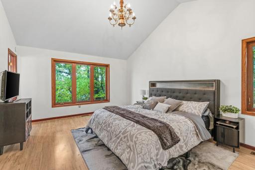 The spacious primary suite showcases vaulted ceilings, a 3/4 On-suite bath with glass incased shower, a walk-in closet and beautiful views of the water from EVERY window.