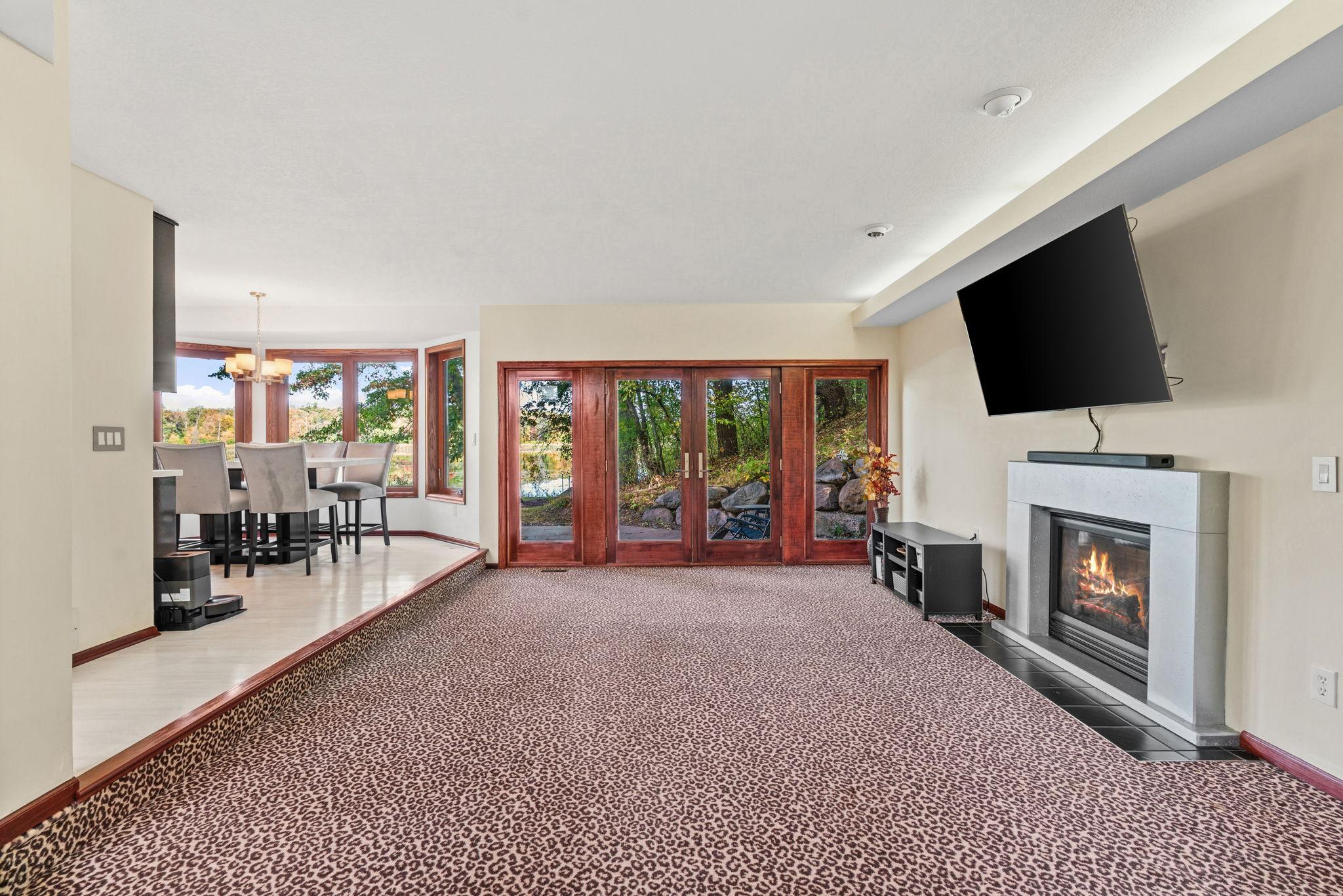 French doors open to the patio, creating an easy connection to the expansive backyard and peaceful natural surroundings!