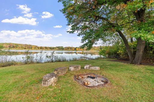 Enjoy 2 full acres of privacy, mature trees, a dock, fire pit, patio, and peaceful views of the water.