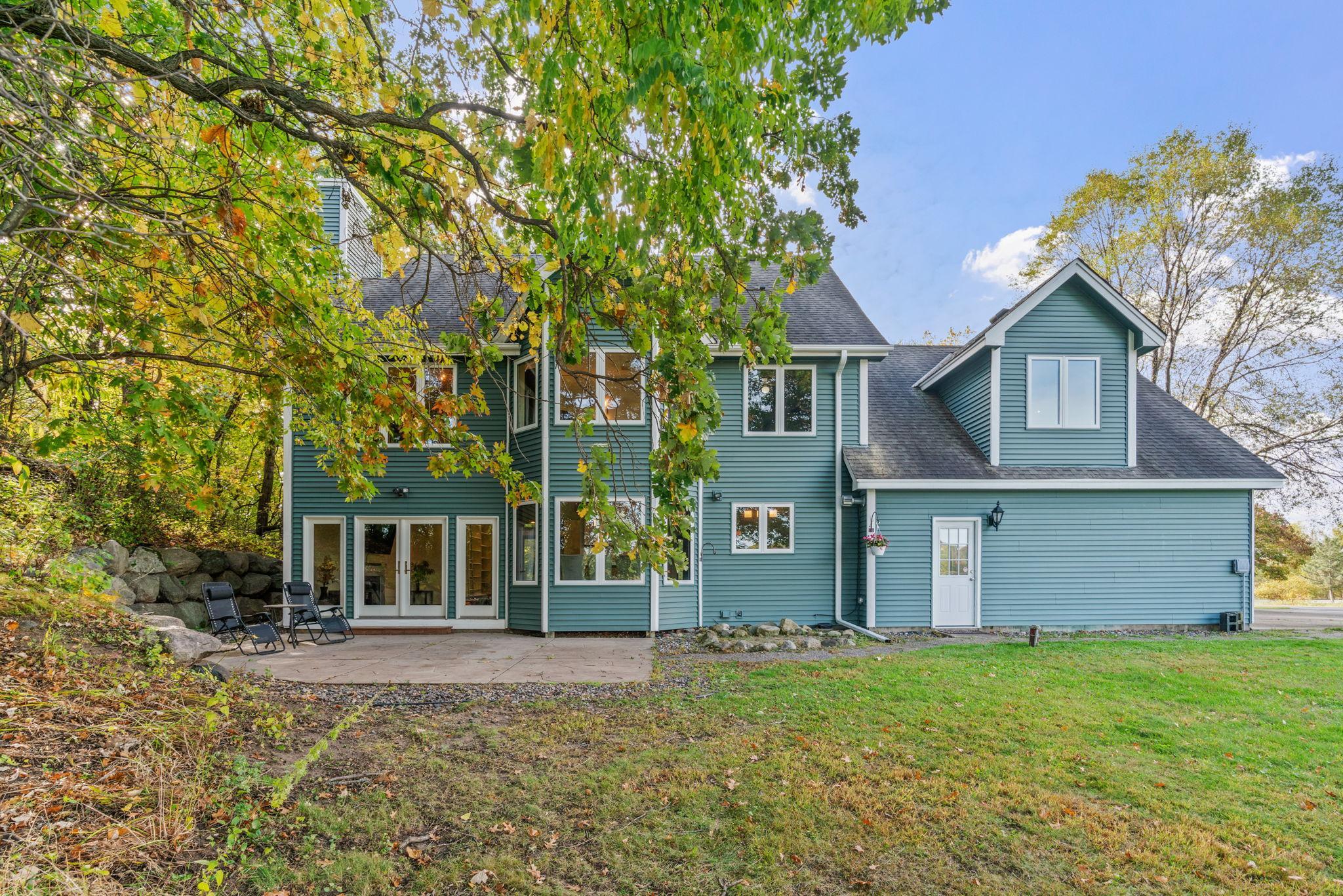 Enjoy 2 full acres of privacy, mature trees, a dock, fire pit, patio, and peaceful views of the water