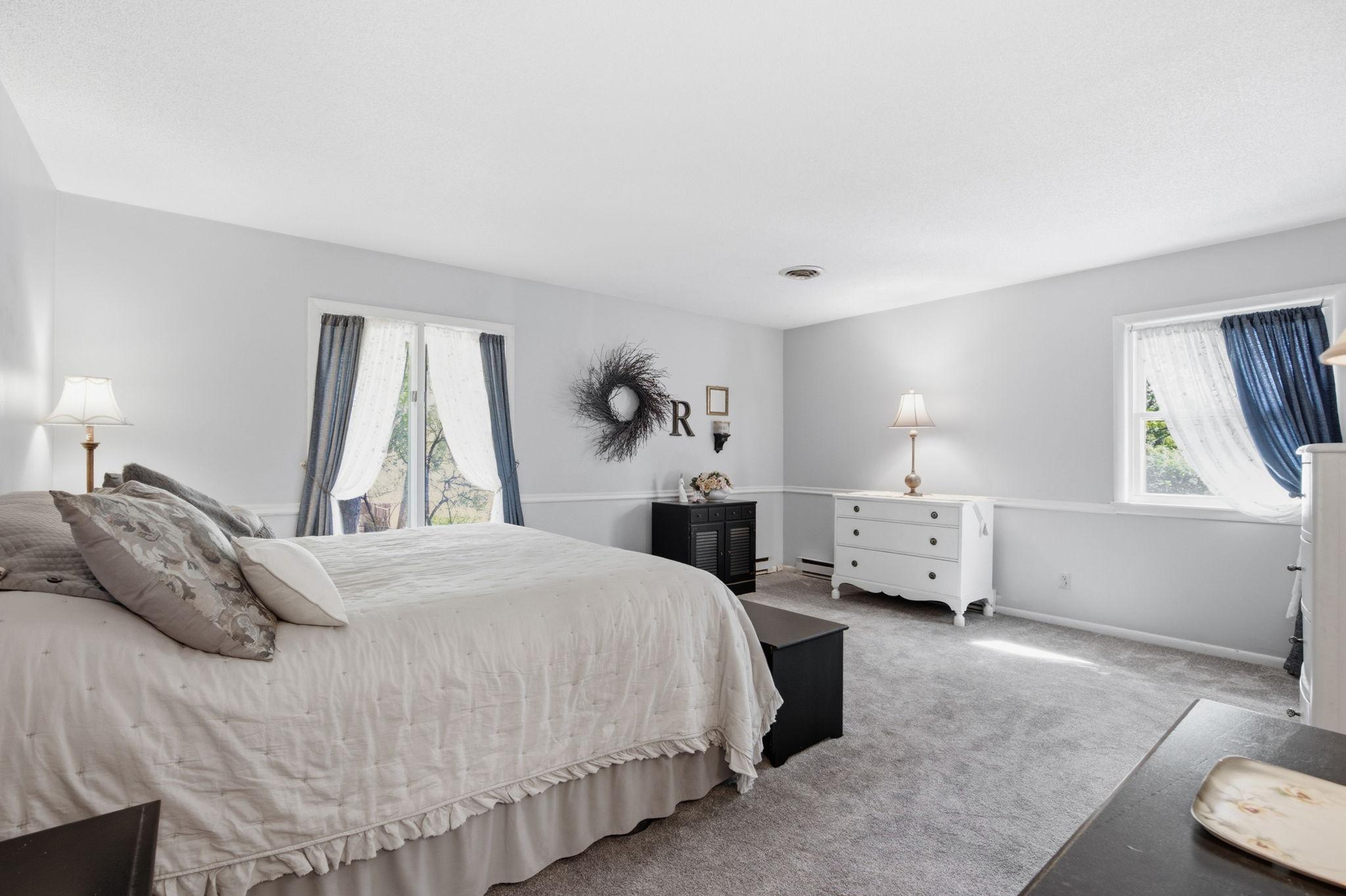 The spacious primary bedroom offers more natural lighting and a private ensuite.