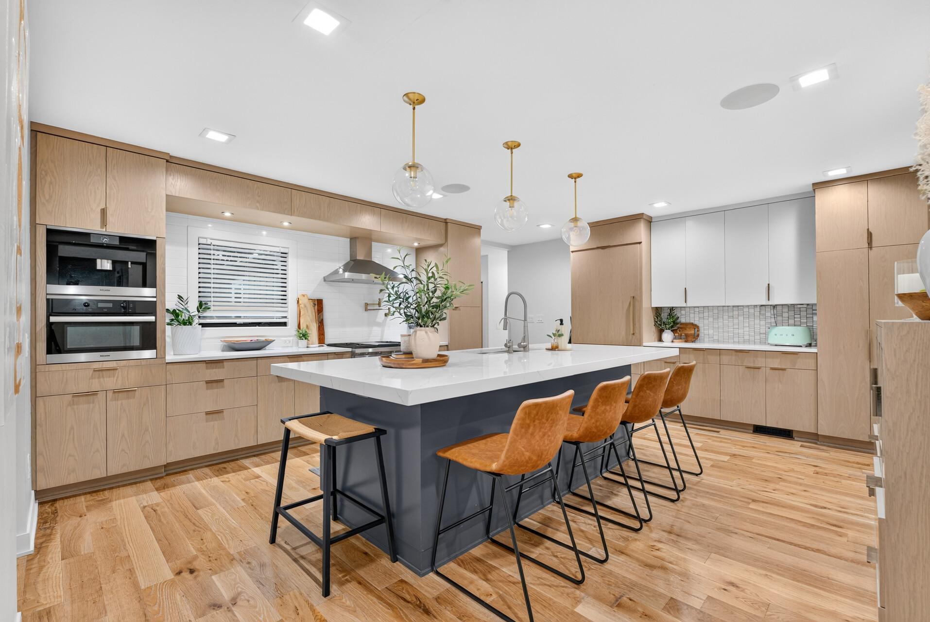 Remodeled kitchen with a mix of natural wood and painted cabinetry, solid white oak flooring and extensive storage.