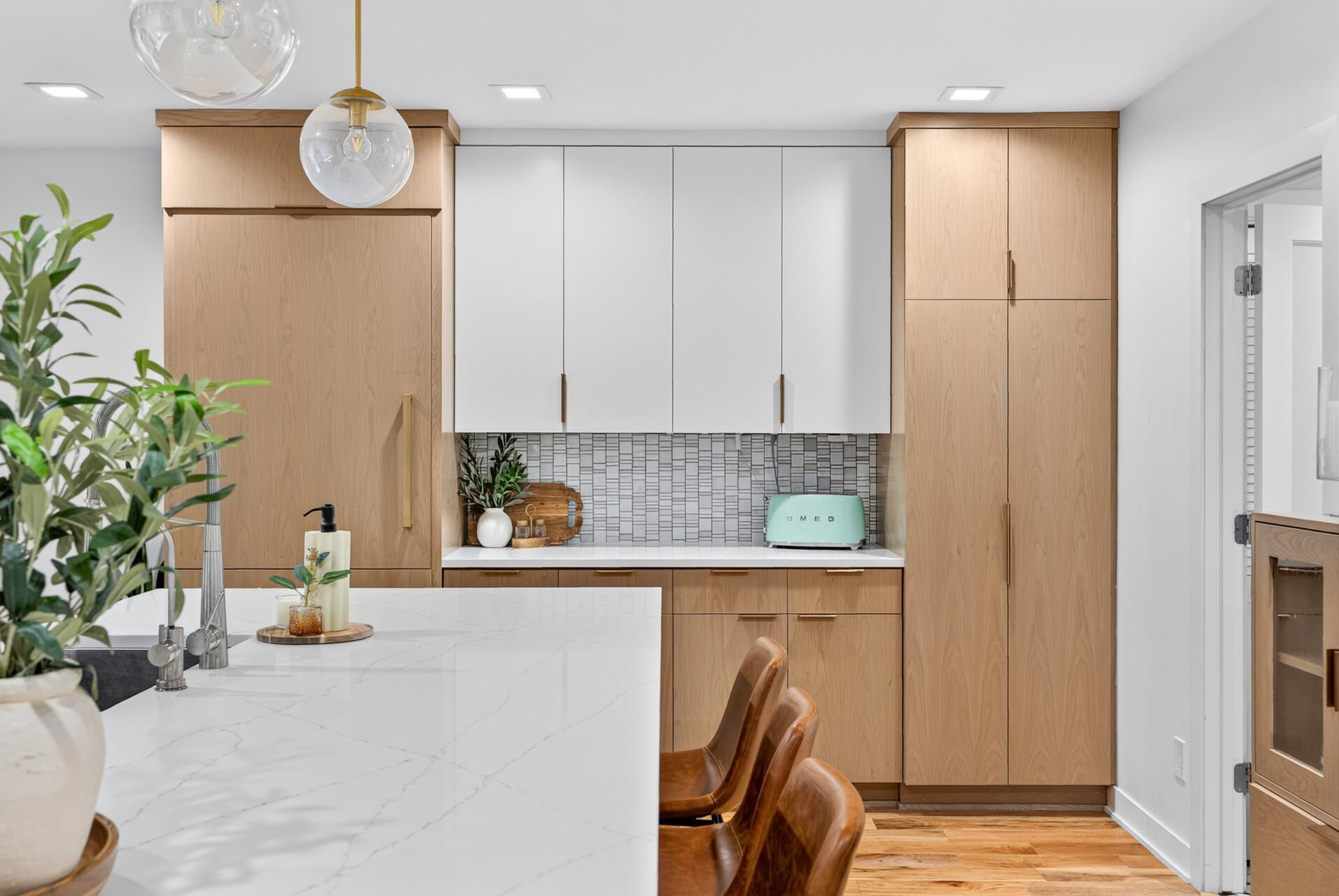 Additional pantry cabinetry and built-in paneled Subzero refrigerator with accent tiled backsplash. The additional counter space provide excellent kitchen storage and a dedicated serving or beverage area.