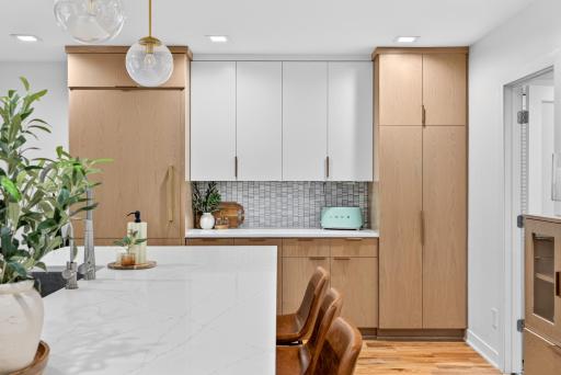 Additional pantry cabinetry and built-in paneled Subzero refrigerator with accent tiled backsplash. The additional counter space provide excellent kitchen storage and a dedicated serving or beverage area.