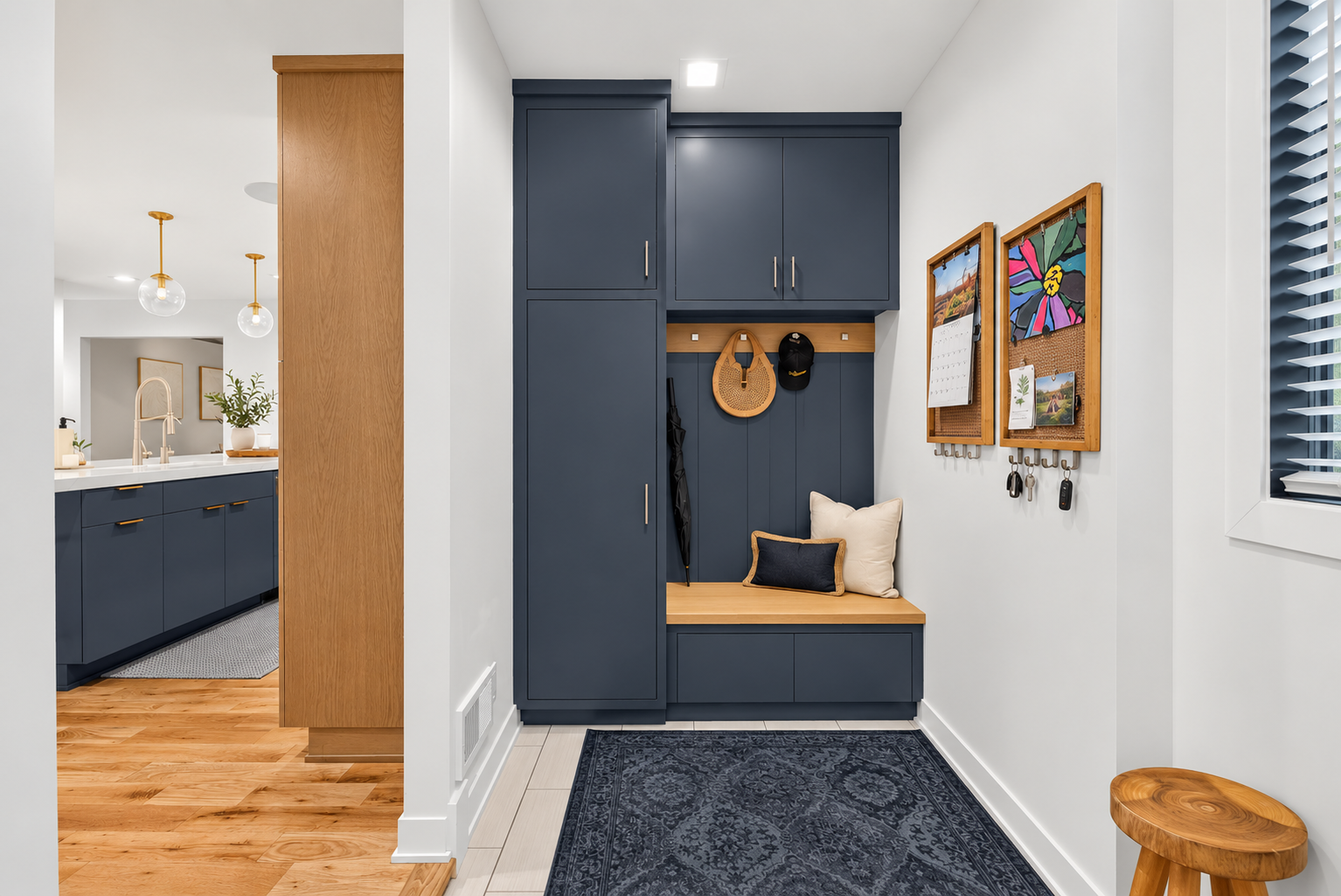Built-in mudroom storage with bench, cabinetry and convenient drop zone just off the kitchen.
