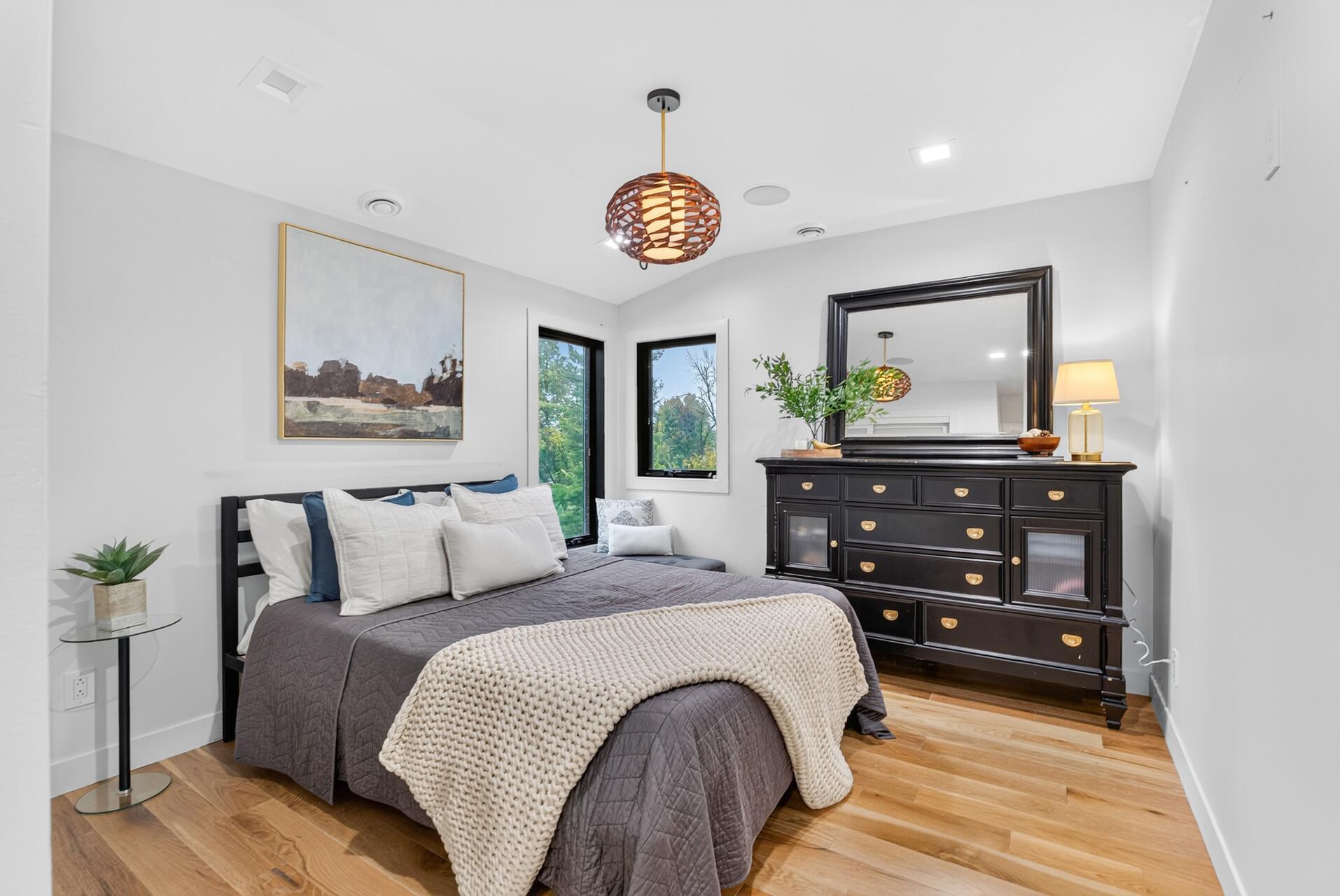 2nd bedroom on upper level with hardwood floors, recessed lighting and corner windows overlooking the side and backyard.