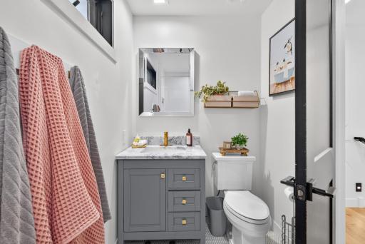 2nd upper level updated bath with modern fixtures and penny tile flooring.