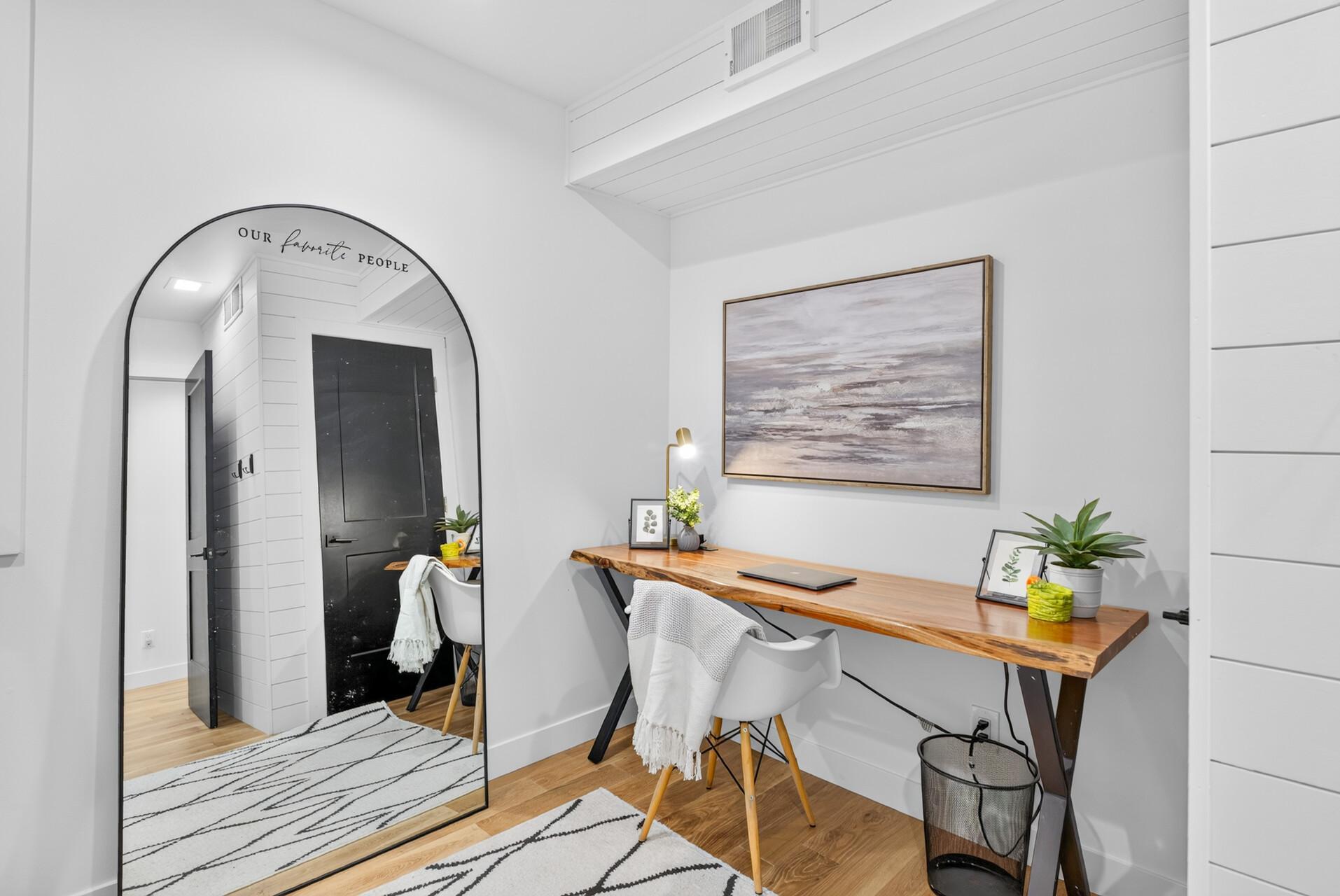 Upper level office/nursery/workout room with hardwood floors and shiplap detail.