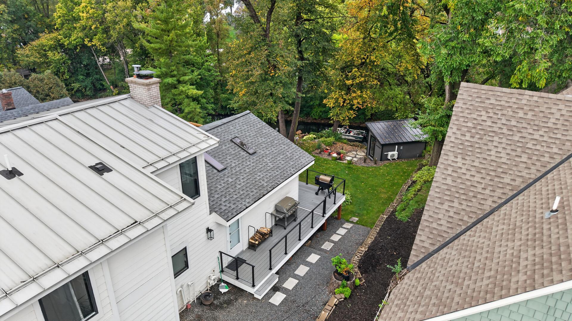 View of side path along home's deck leading to backyard.