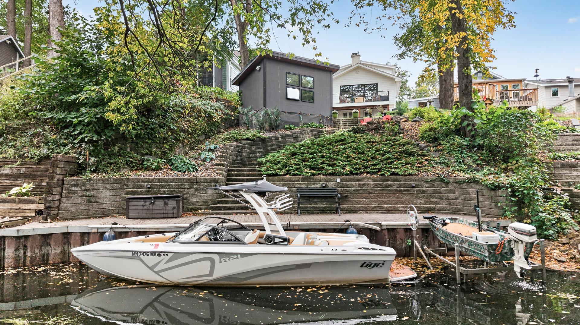 Channel-side view highlighting the property’s waterfront setting, private dock with direct water access.