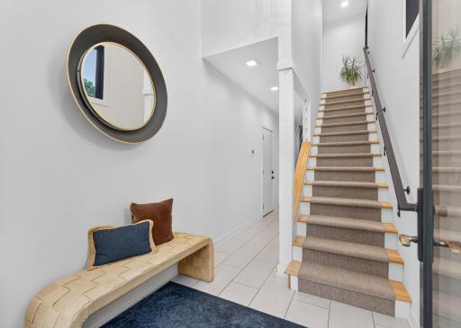 Two-story entry addition with tiled heated floor and direct access to the upper level.