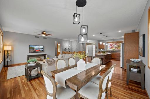 The dining area flows seamlessly into the kitchen and great room, creating a welcoming space for gathering and entertaining.