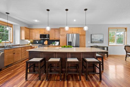 A spacious kitchen island with quartz countertops offers plenty of room for meal prep and casual seating
