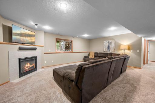 Gather in the inviting lower level family room, where a fireplace adds warmth to movie nights and quiet evenings.