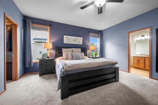 The main level primary suite offers a relaxing retreat with two walk in closets and a private bathroom.