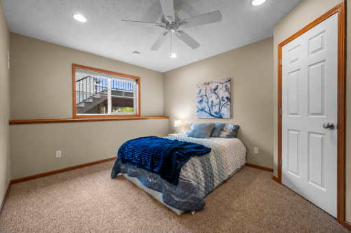 A comfortable lower level bedroom offers a welcoming space for guests.