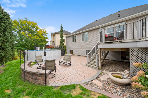 A spacious paver patio and elevated deck offer multiple places to grill, dine and relax outdoors.