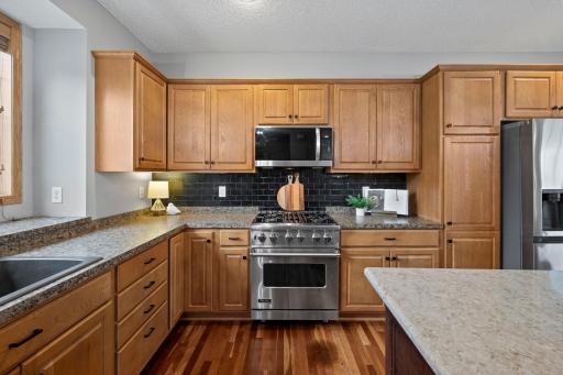 Professional appliances and tile backsplash.