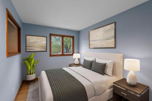 Main-level bedroom 3 features hardwood floors and great natural light *This photo has been virtually staged