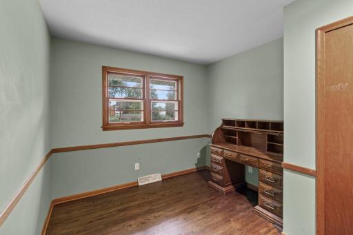 Main-level bedroom 4 offers hardwood floors and plenty of flexibility for a bedroom or home office