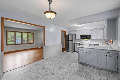 The generously sized kitchen offers plenty of cabinet and counter space, plus convenient peninsula and an open connection to the main living areas