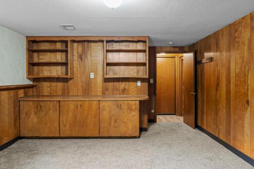 Built-in shelving and cabinetry add unique charm and useful storage to the lower level