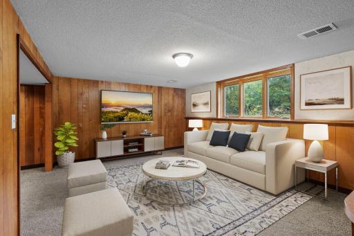 The lower-level family room provides plenty of space for relaxing, movie nights, entertaining, and more *This photo has been virtually staged