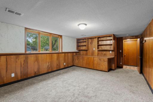 Another view of the spacious family room highlights the built-in shelving, natural light, and generous amount of usable living space