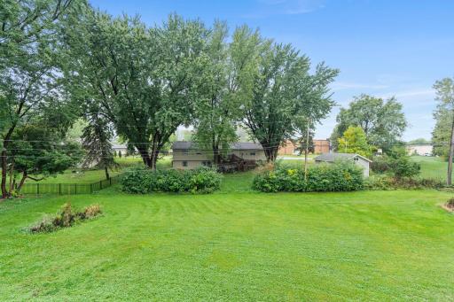 A beautiful backyard framed by mature trees provides the space and flexibility that can be hard to find in this area