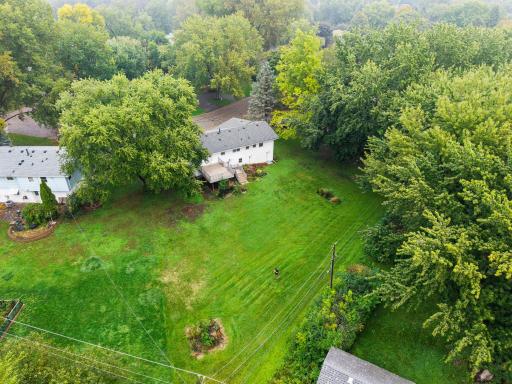 This aerial view really shows off the generous lot with an impressive amount of green space surrounded by mature trees