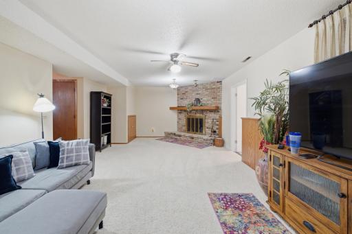 Family Room features ceiling fan, brick fireplace