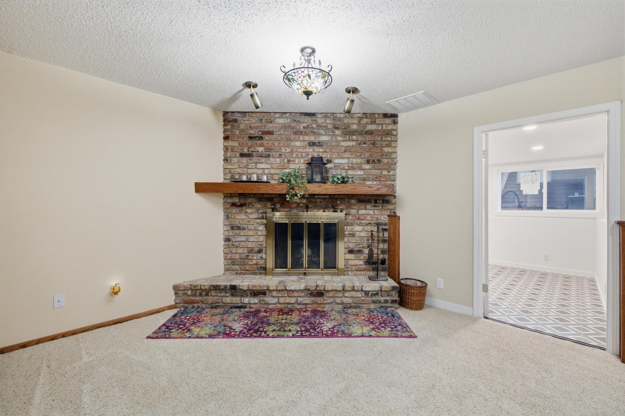Family Room brick fireplace, hearth and wood mantle