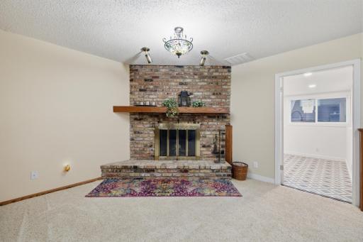 Family Room brick fireplace, hearth and wood mantle