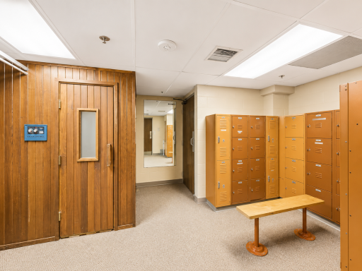 Locker rooms featuring showers, lockers and a sauna for a spa-like experience.