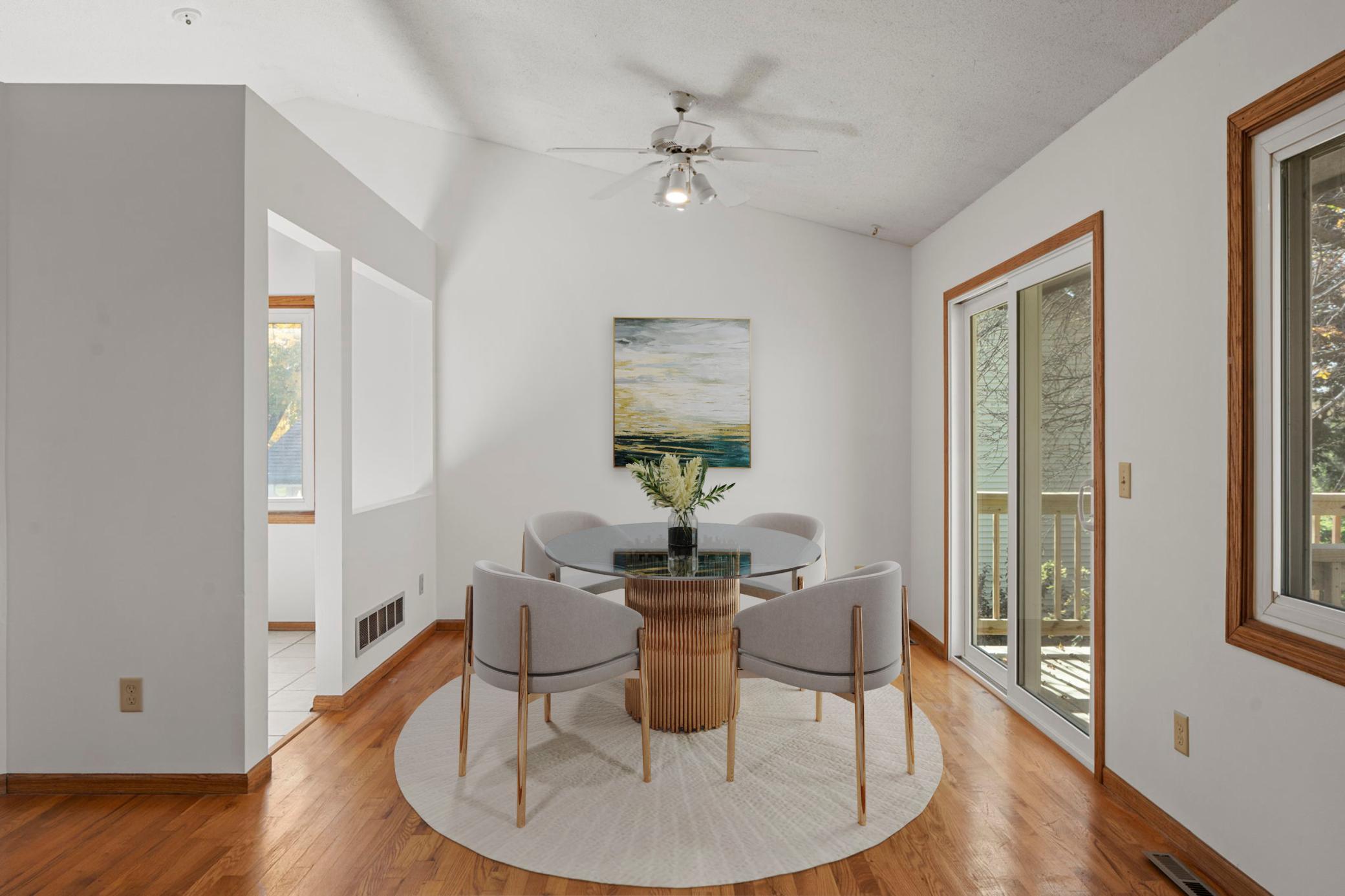 Dining room overlooking the deck and private backyard (virtually staged).
