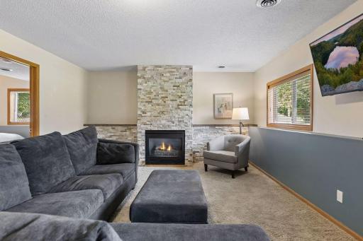 Stay cozy by the gas fireplace with beautiful stone surround