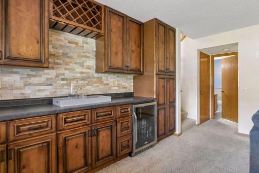 Convenient dry bar with ample storage for hosting