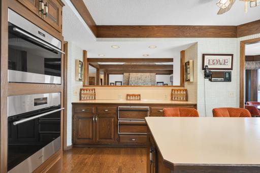 An open pass-through keeps the kitchen connected to the living room and its lakeside views.