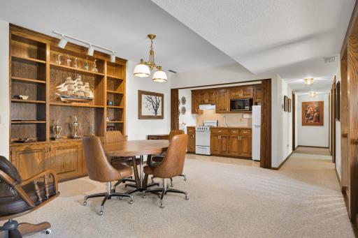 The lower level offers a flexible gathering space complete with a second galley kitchen and built-in cabinetry.